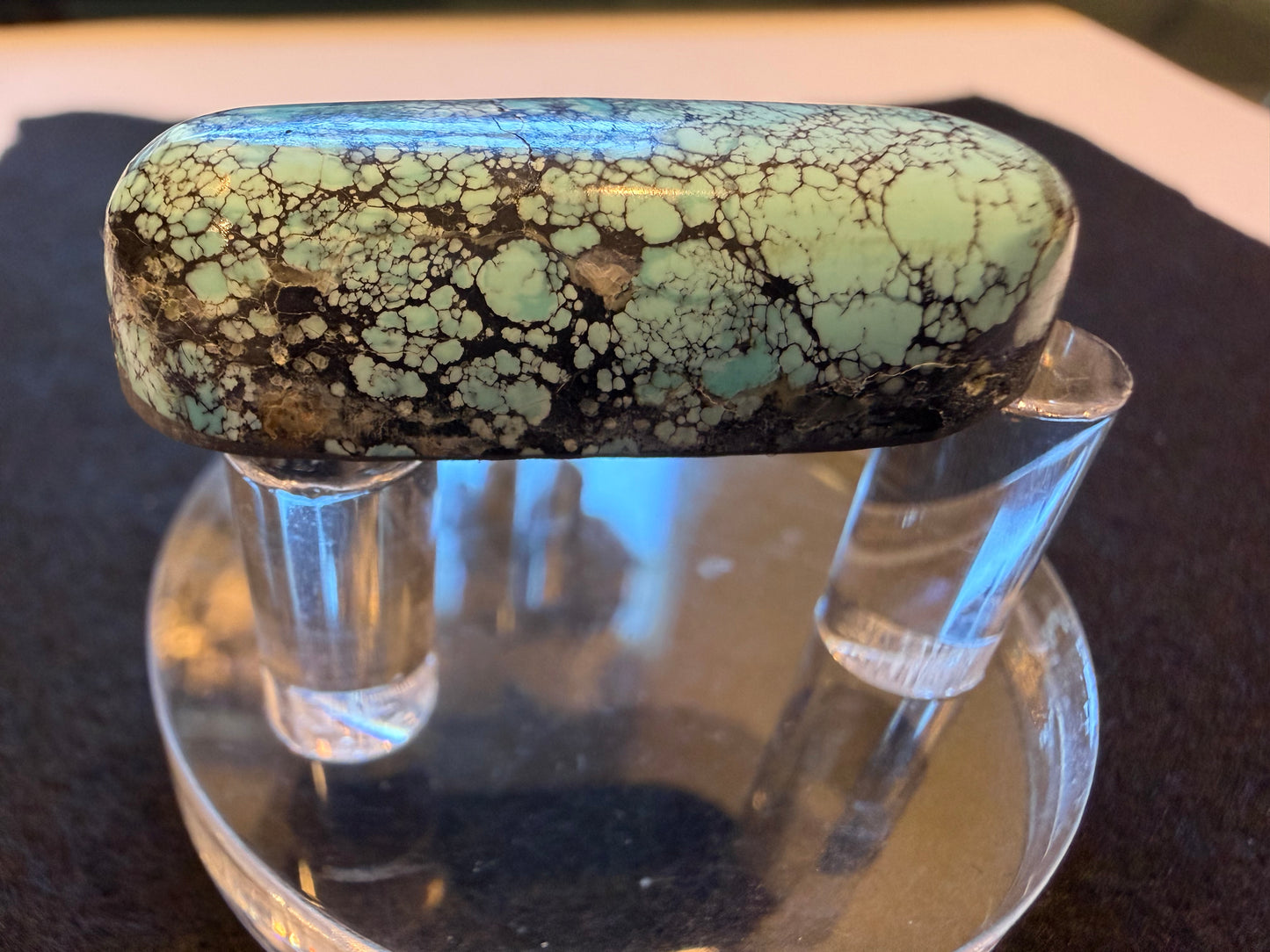 Red River high dome Turquoise cab shown on the side with a thin backing applied