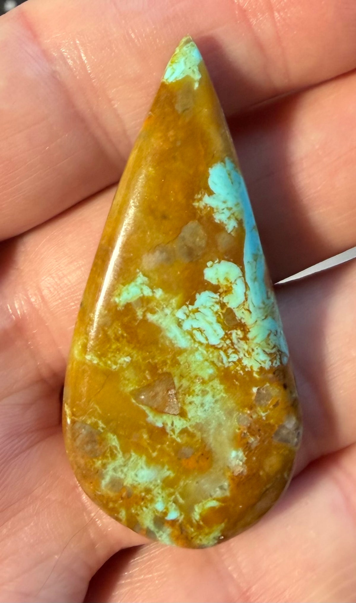Number 8 turquoise cabochon 8-007 in hand